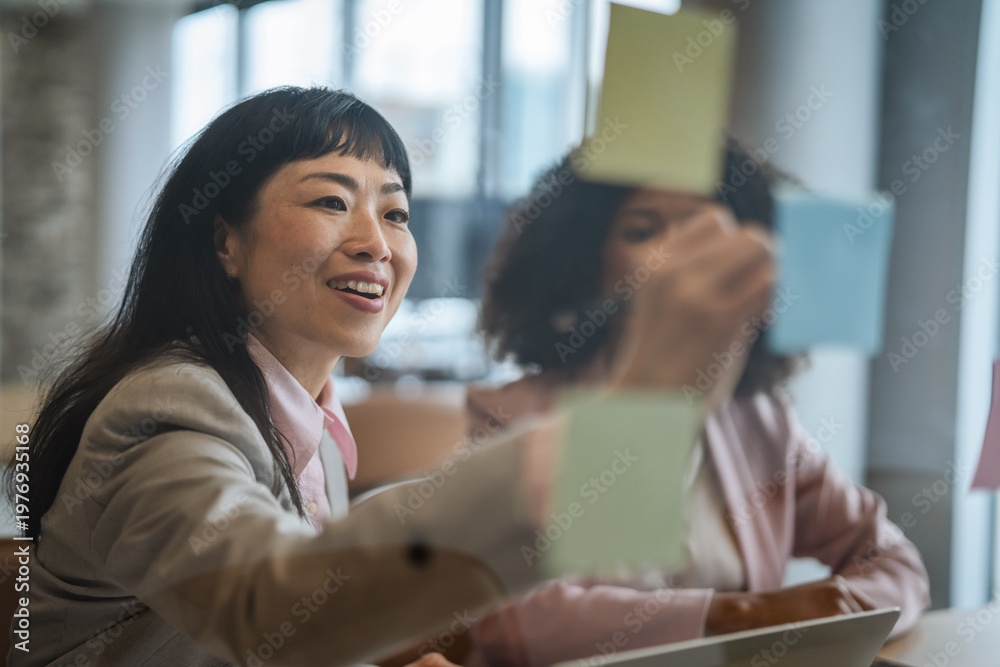 Obraz premium Focused businesswoman organizing sticky notes for strategic planning