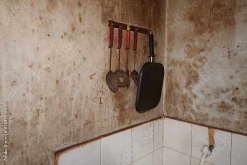 Photos Weathered wall holds hanging kitchen tools