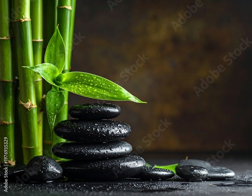A serene arrangement of stacked stones and bamboo with a green leaf
