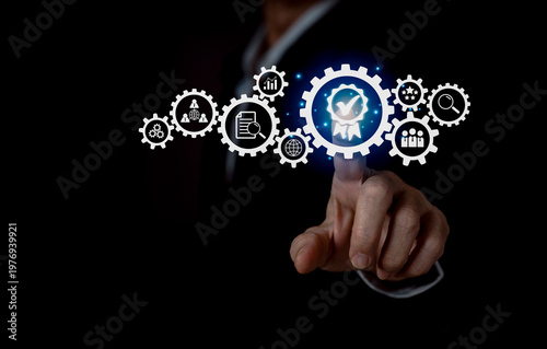 Businessman touching a digital gear interface symbolizing the driving mechanism of a business network, innovation, teamwork, and system integration. Modern technology and corporate strategy concept .
