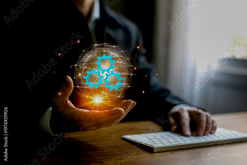 Businessman presenting a digital business network and gear system on his palm, symbolizing connectivity, automation, and strategic business operations. Modern technology and innovation concept .