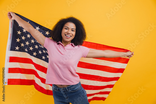 African American woman proudly holding American flag