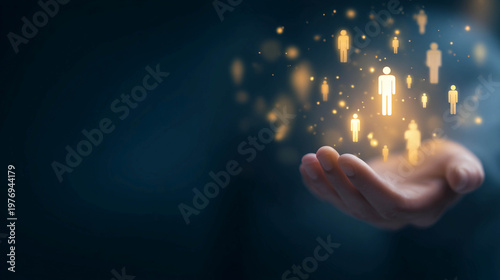 A human hand on a dark background, with glowing yellow icons of people floating above it, representing the concept of human resources management, customer base, leadership, and teamwork.