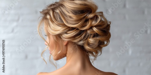 Elegant blonde updo hairstyle with soft curls and loose strands framing the face