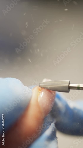 Close-up of dust flying while removing gel with a manicure machine. High quality 4k footage