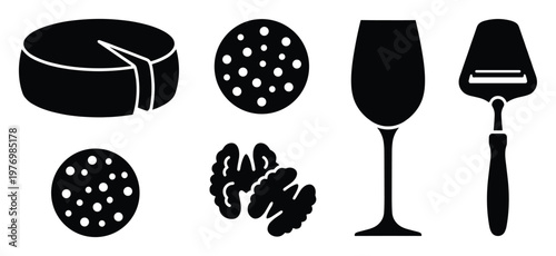 Assortment of gourmet food and drink items including cheese wheel, sliced sausage, walnuts, a wine glass, and cheese slicer ideal for upscale culinary branding and sophisticated kitchen