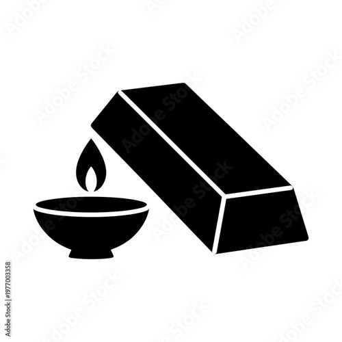 Gold ingot and flame in a bowl on a white surface symbolizing investment