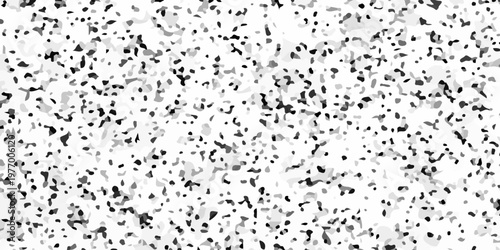 Black and white terrazzo texture seamless pattern with dark stone chips on light marble. A densely speckled abstract texture with varying shades of gray and black against a white background