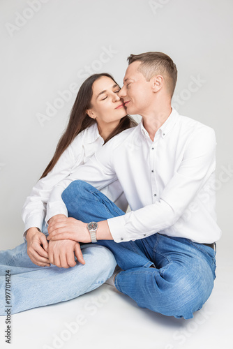 Loving Kissing Caucasian Happy Adorable Couple As Caring Loving Family Man And Woman In Casual Clothing Together Embracing Isolated on White Background