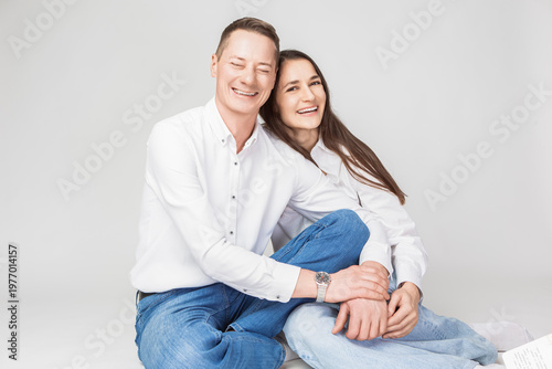 Happy Couple As Caring Loving Family Man And Woman In Casual Clothing Together Embracing Isolated on White Background As Studio Portrait
