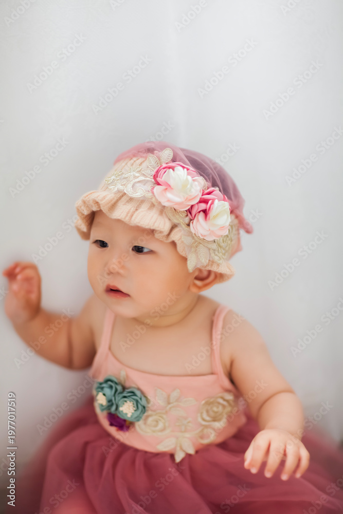 Fototapeta premium Cute Asian baby girl wearing a woolen hat