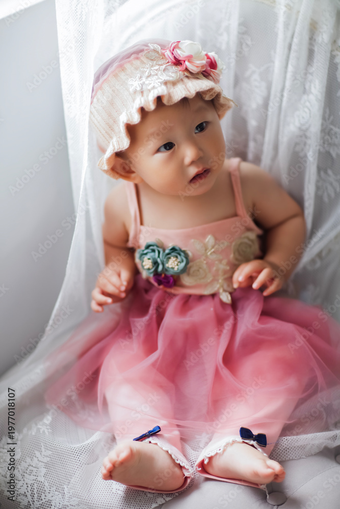 Fototapeta premium Cute Asian baby girl wearing a woolen hat
