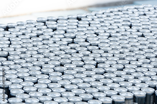 Stack of aluminum beer cans forming repetitive industrial