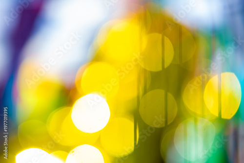 Abstract colorful bokeh lights background with yellow and blue glow