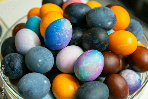 Colorful dyed Easter eggs in glass bowl – traditional holiday decoration