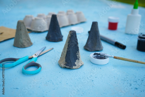 A simple DIY childrens craft is a family of mice made from cardboard egg packaging. Step 2 color it in gray, close up.