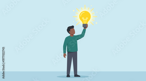 Man holding up a glowing light bulb representing a great creative idea or inspiration