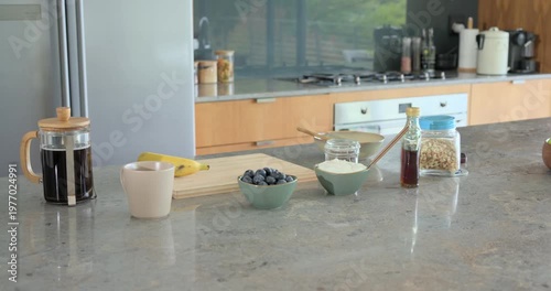 Camera is panning right, revealing breakfast vignette on countertop to highlight cereal jar