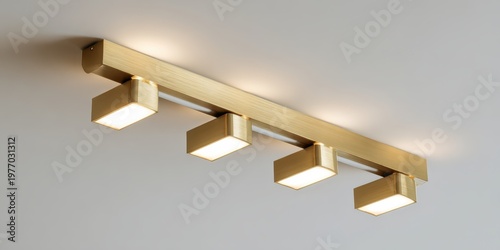 Modern ceiling with sleek golden metal track lights. Spot lighting led system. Closeup Room spotlights for interior design, commercial illumination. Minimalist white surface. Contemporary ambiance