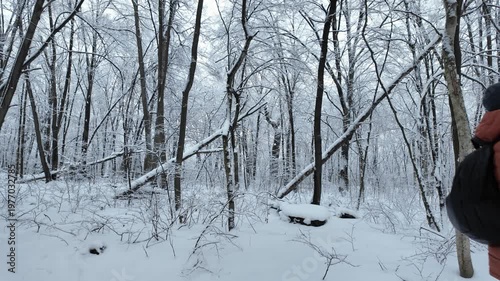 Man In Orange Jacket Walking In Snowy Winter Forest