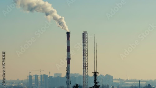 White Smoke From Industrial Chimney Over City Skyline In Kyiv During Winter