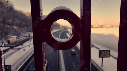 Winter View of Road Traffic Through Pedestrian Bridge Railing