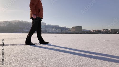 Man Walking On Frozen Dnieper River In Sunny Winter Day