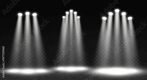 Stage spotlights illuminating a dark background with dramatic light beams