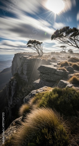 Dramatic Cliffside Landscape Under Cloudy Sky.