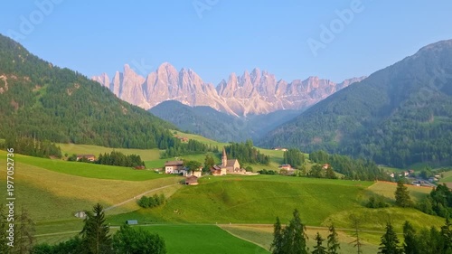 Iconic landscape in Val di Funes, Italy, with famous Santa Maddalena village and Odle mountains in the background, in Dolomites, South Tyrol, at sunset, in springtime. Timelapse