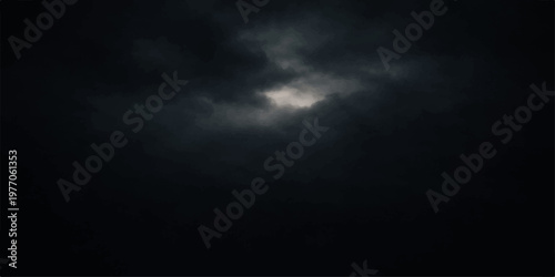 A dramatic night sky reveals a bright moon emerging through dark stormy clouds to create a moody nature cloudscape