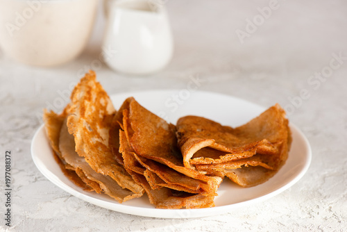 Gluten-free thin crepes without sugar and lactose on a white plate.