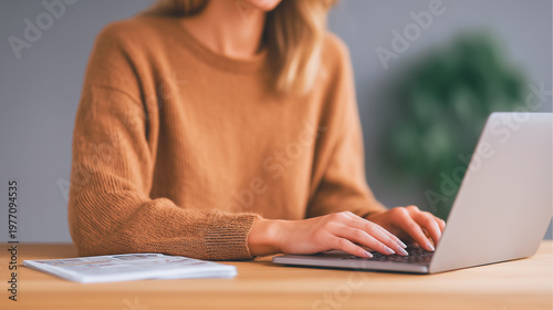 Business woman working on laptop at home office, typing on keyboard for online study or remote career. Professional female freelancer at desk.