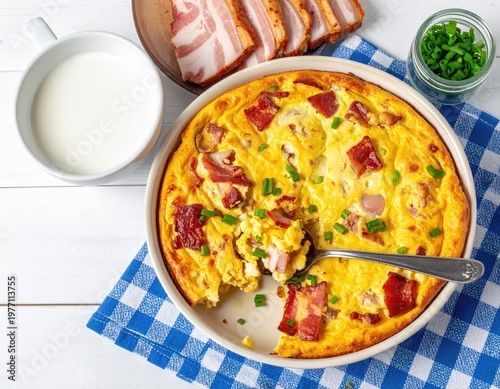 Baked egg dish with bacon, milk, chives, and bacon slices