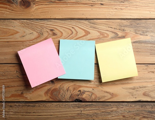Three colorful sticky notes on a wooden surface (3)