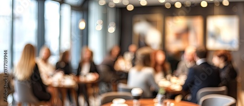 Blurry group of people enjoying a social gathering in a modern restaurant or cafe