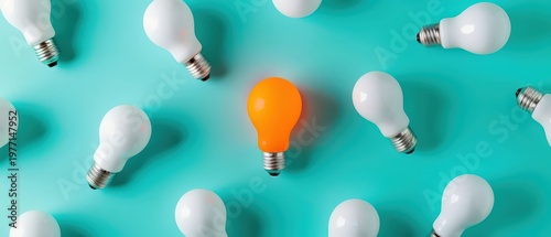 Creative idea concept showing one glowing light bulb standing out among others, symbolizing innovation, uniqueness, inspiration and fresh thinking for business and creativity.