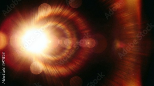 Circular golden light burst with glowing concentric rings on black background