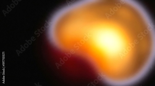Warm glowing orange light orb inside circular frame on dark background