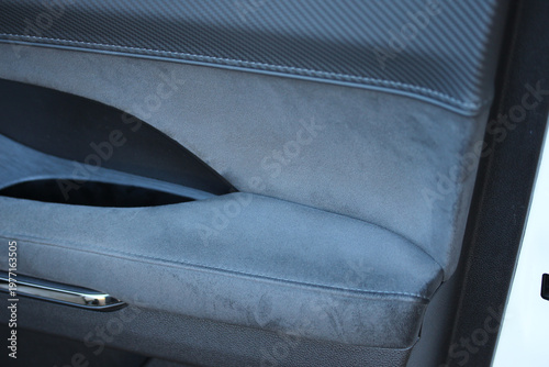 Black suede and textured leather door pocket in a modern luxury vehicle