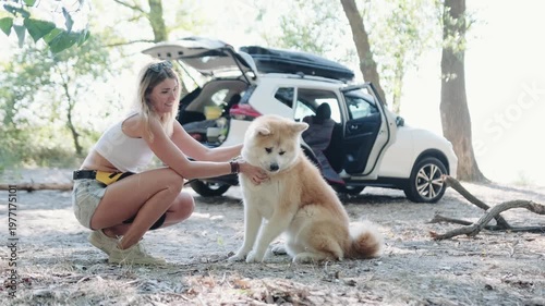 Happy woman and her cute dog spending time on the nature