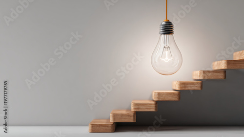 A minimalist image featuring a hanging light bulb above wooden stairs, creating a modern and inviting atmosphere.