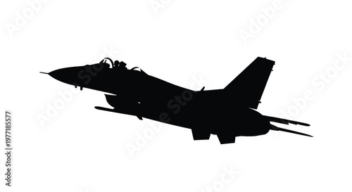 Silhouette of a military jet fighter in mid flight against a white background