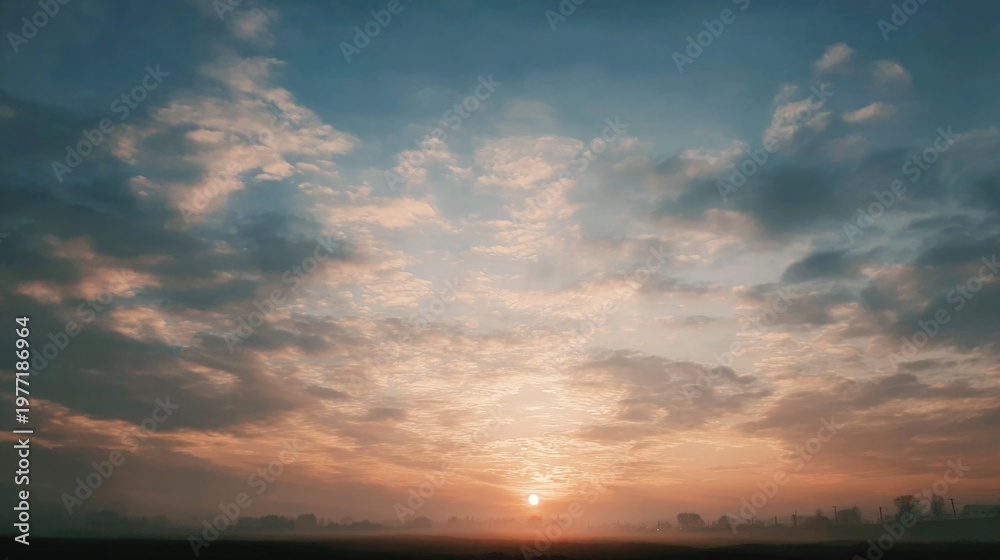 Obraz premium Peaceful Sunrise Over a Serene Horizon with Soft Clouds and Golden Sunlight in the Early Morning Sky
