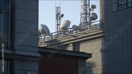 Rooftop of a modern urban building bristling with satellite dishes and telecom towers, highlighting wireless networks, data transmission and global connectivity under a clear sky