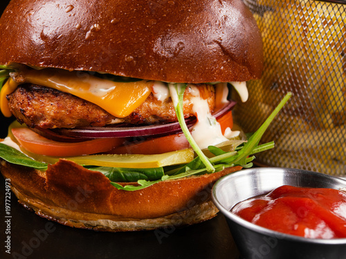 Juicy beef burger with cheese, tomato, onion