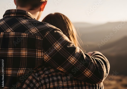 Couple Embracing on a Hilltop at Sunset.