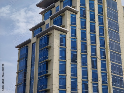 a magnificent and luxurious hotel building with blue glass