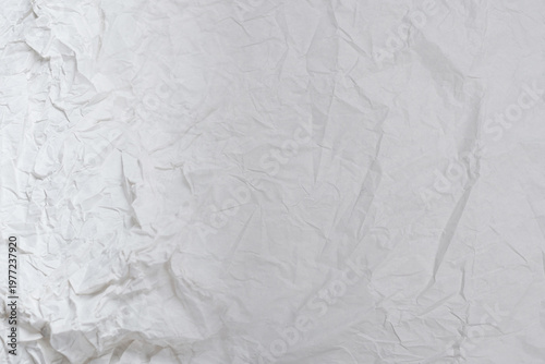 Crumpled white paper background.