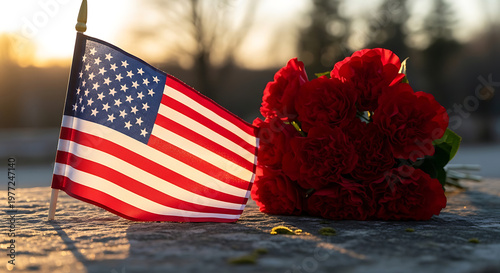 American flag waving over a grave under a clear sky